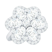 Large flower-shaped moissanite engagement ring by Rosec Jewels featuring sparkling gemstone and intricate band design.