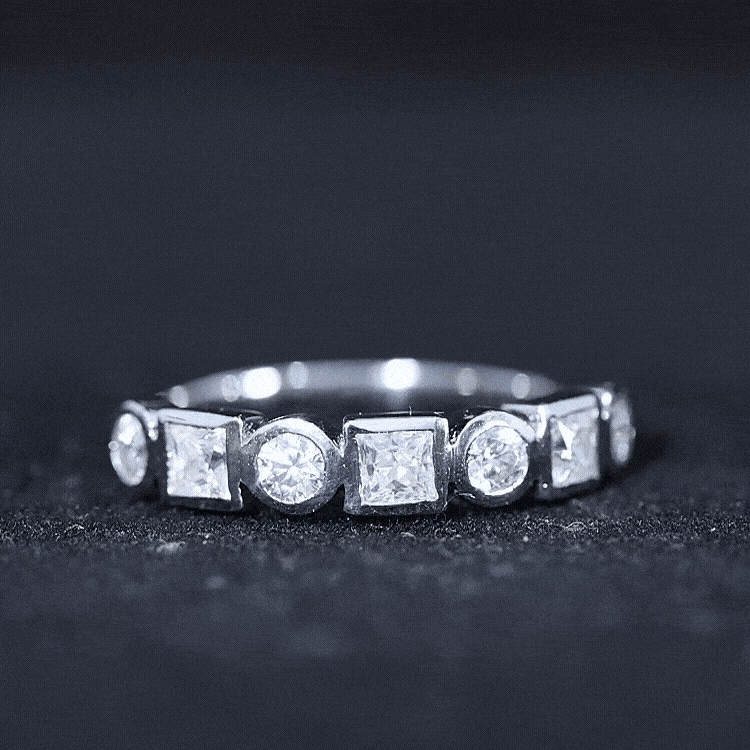 Rosec Jewels moissanite half eternity band ring with bezel-set diamonds, showcasing a sparkling, elegant design.