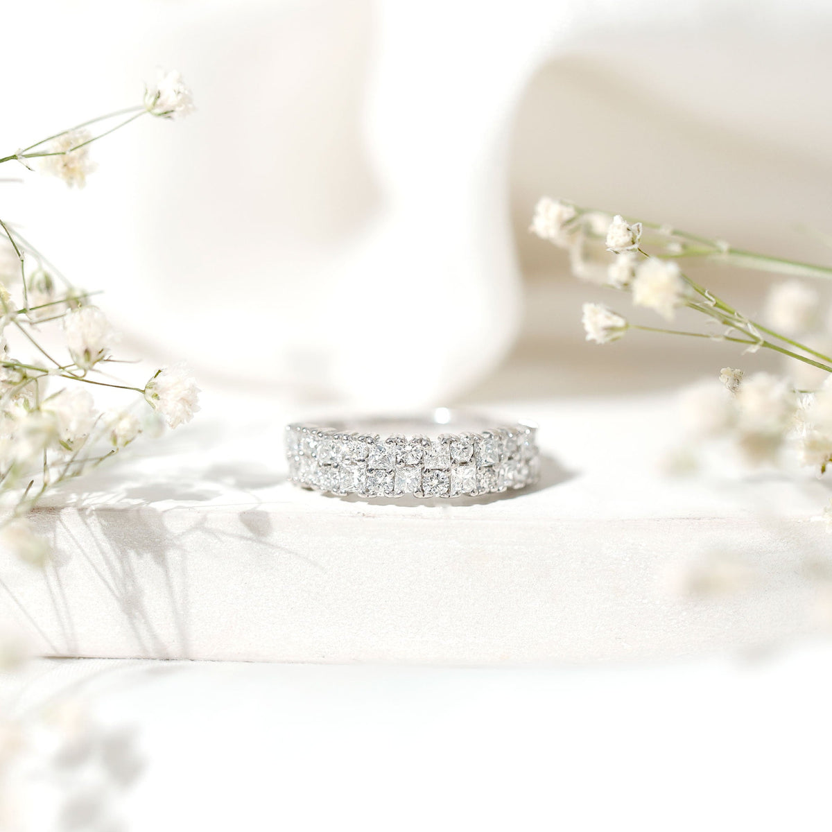 Double row moissanite eternity wedding band ring with sparkling stones, crafted by Rosec Jewels.