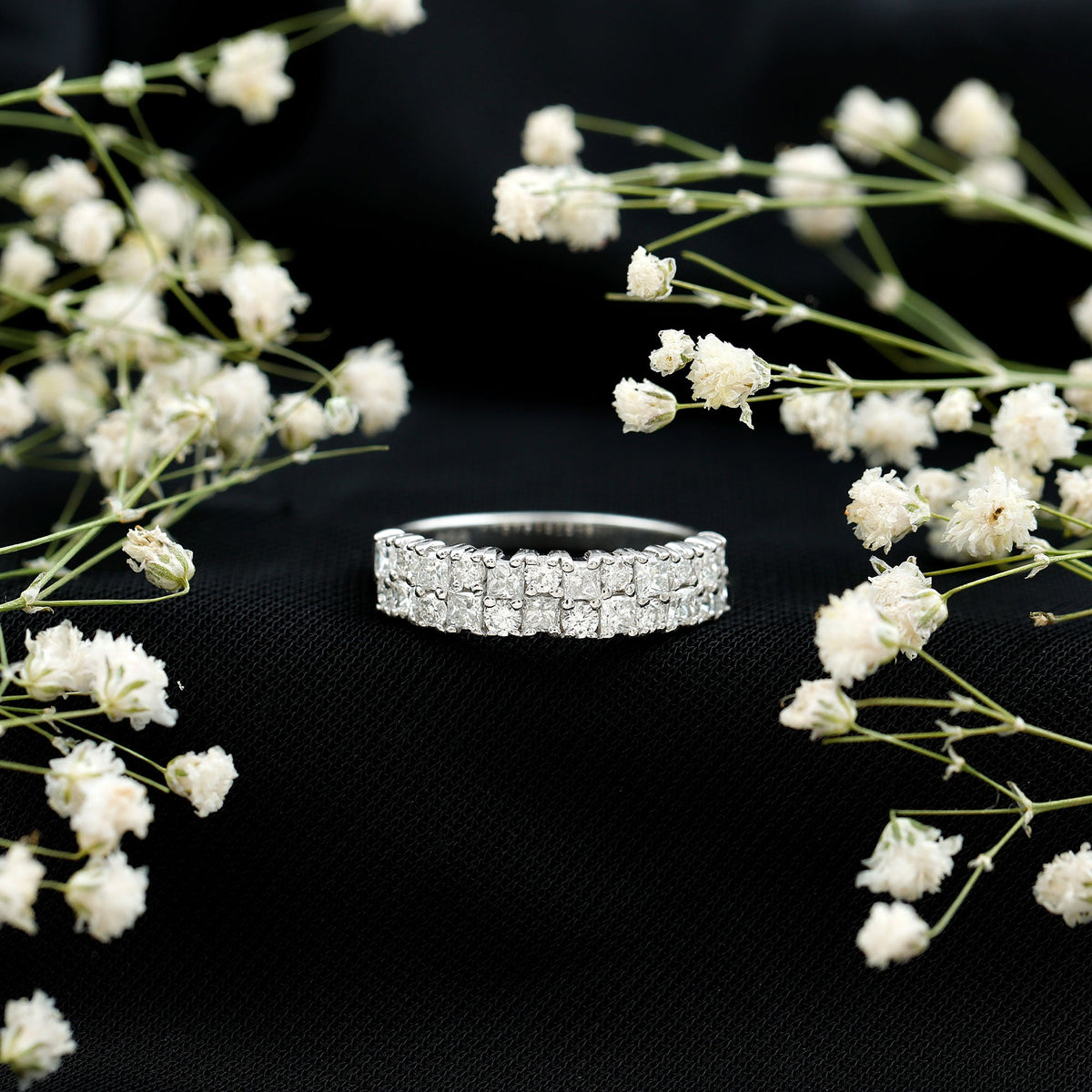 Double row moissanite eternity wedding band from Rosec Jewels featuring sparkling stones and a sleek, polished silver finish.