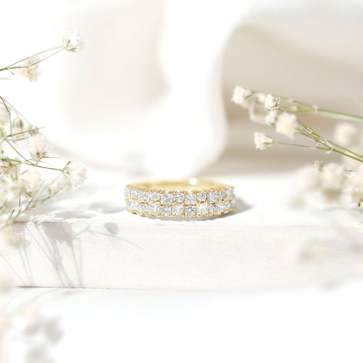 Double row Moissanite eternity wedding band from Rosec Jewels, showcasing sparkling stones and a sleek silver finish.