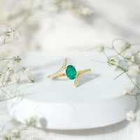 Oval Shaped Emerald Bypass Engagement Ring with Diamonds