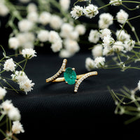 Oval Shaped Emerald Bypass Engagement Ring with Diamonds