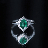 Vintage Looking Emerald Oval Engagement Ring with Diamond Halo