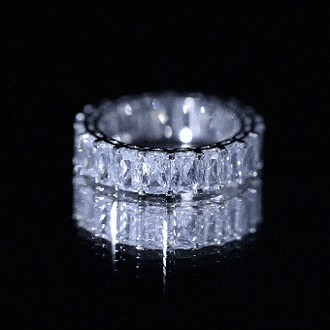 Yellow emerald cut zircon eternity band ring by Rosec Jewels featuring a full circle of sparkling stones on a gold-tone band.