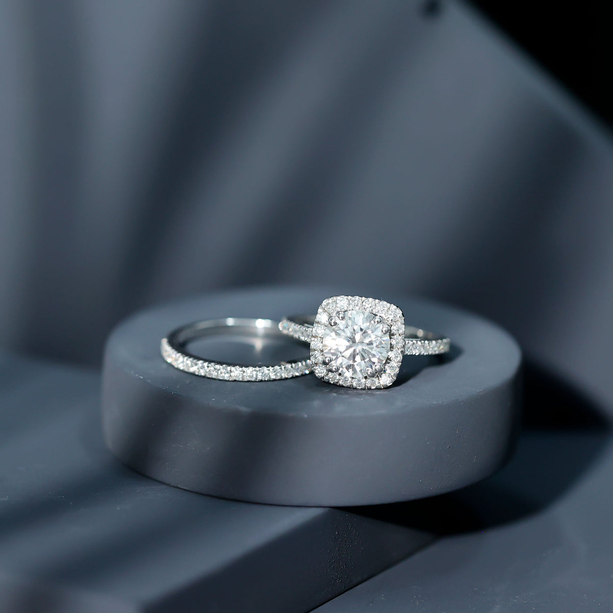 Two-carat cubic zirconia engagement ring with matching wedding band in silver, featuring sparkling stones and intricate design.