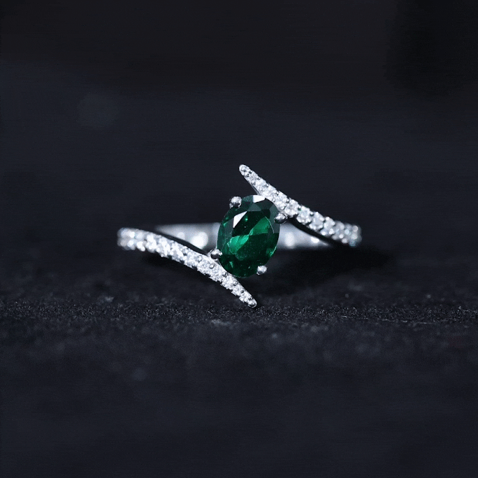 Oval cut lab grown emerald engagement ring with diamond bypass shank by Rosec Jewels, showcasing a 0.8 carat center stone.