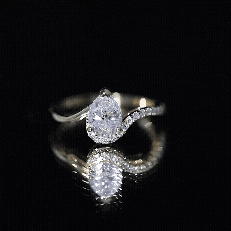 Yellow gold pear-shaped moissanite engagement ring by Rosec Jewels featuring a sparkling center stone and elegant band design.