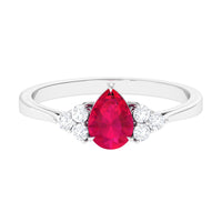 Natural 0.8 Carat Ruby teardrop engagement ring with diamond trio accents, crafted by Rosec Jewels.