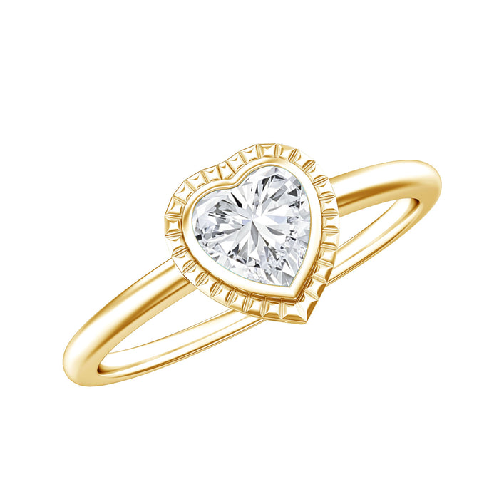Lab grown diamond heart solitaire ring with engraved details, featuring a sparkling diamond set in a delicate band.