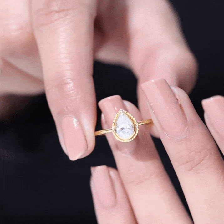 Yellow gold pear cut lab grown diamond solitaire ring with engraved details, featuring elegant design and sparkling center stone.