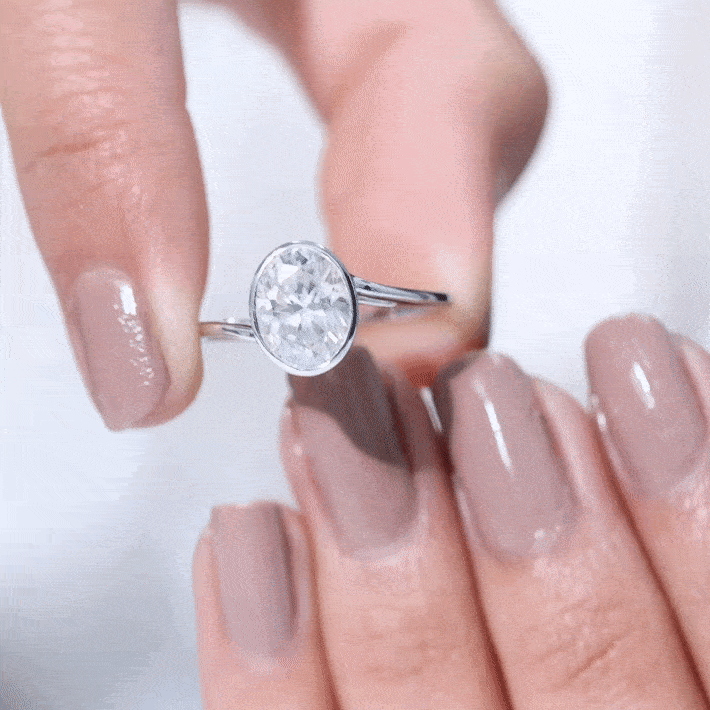 Oval shape lab-grown diamond solitaire bypass ring by Rosec Jewels featuring a sleek gold band and elegant design.
