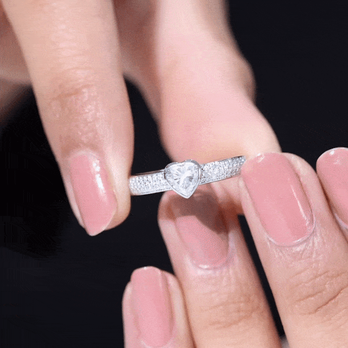Yellow gold heart-shaped lab-grown diamond solitaire ring with side stones by Rosec Jewels, showcasing intricate design and sparkling gemstones.