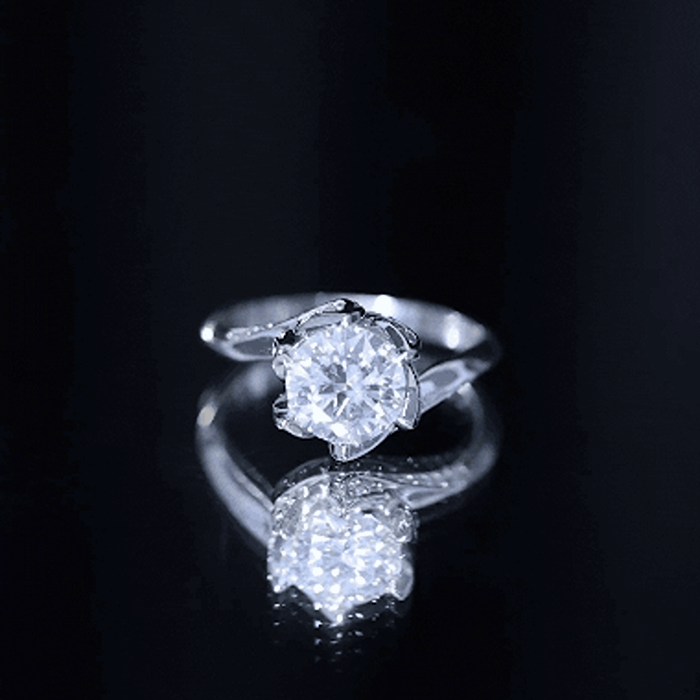 Two-carat moissanite floral engagement ring with bypass shank from Rosec Jewels, featuring intricate floral designs and sparkling stones.