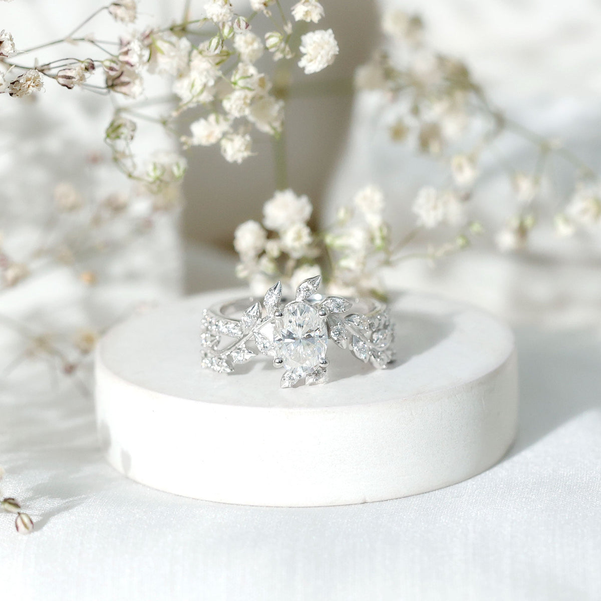 Certified 1.2 carat Moissanite vine engagement ring in silver, featuring intricate design and sparkling gemstones.