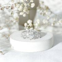 Certified 1.2 carat Moissanite vine engagement ring in silver, featuring intricate design and sparkling gemstones.