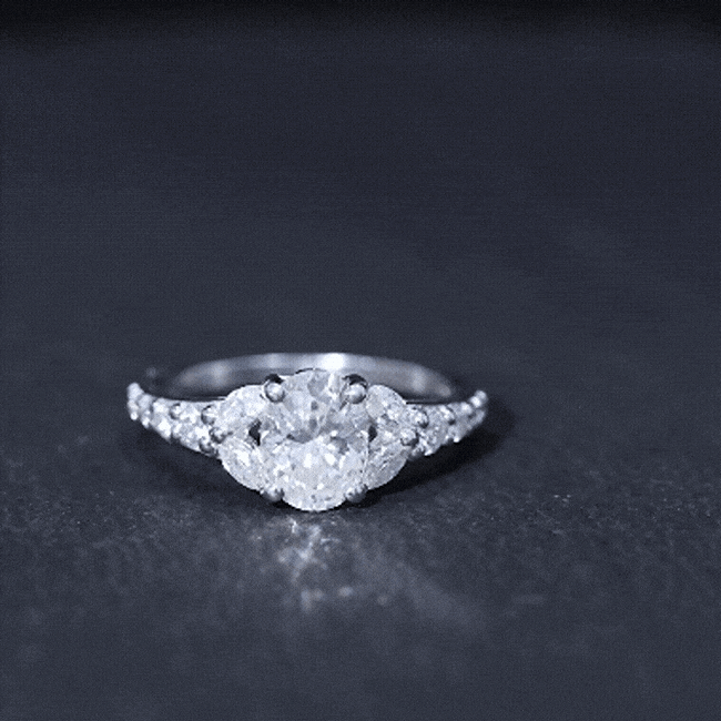 Oval 1.2 carat moissanite engagement ring in 14k gold plated silver with intricate designer details.