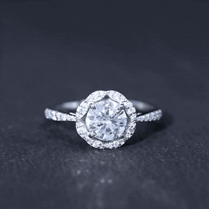 Elegant white moissanite halo engagement ring in gold-plated silver with intricate designer detailing by Rosec Jewels.