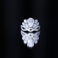 Vintage-inspired moissanite engagement ring with large central stone and intricate band design, by Rosec Jewels.