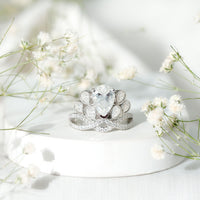 Vintage-inspired moissanite engagement ring featuring a large central stone and intricate band design from Rosec Jewels.