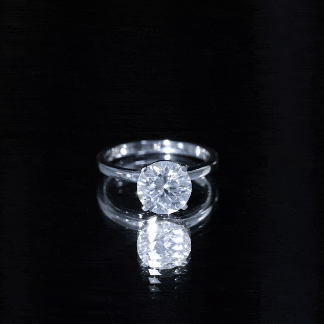 Two-carat round moissanite solitaire engagement ring by Rosec Jewels featuring a sparkling central stone and sleek band design.