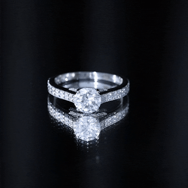 Yellow gold moissanite solitaire engagement ring with side stones from Rosec Jewels, showcasing a 2-carat center stone and elegant design.