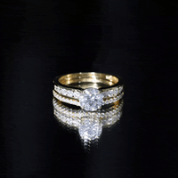 Two-tone rose gold and white gold moissanite engagement ring with matching wedding band, featuring a 2-carat round brilliant cut stone.