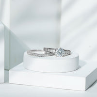 Certified 2 Carat round Moissanite engagement ring with matching wedding band from Rosec Jewels, featuring sparkling gemstone and elegant design.