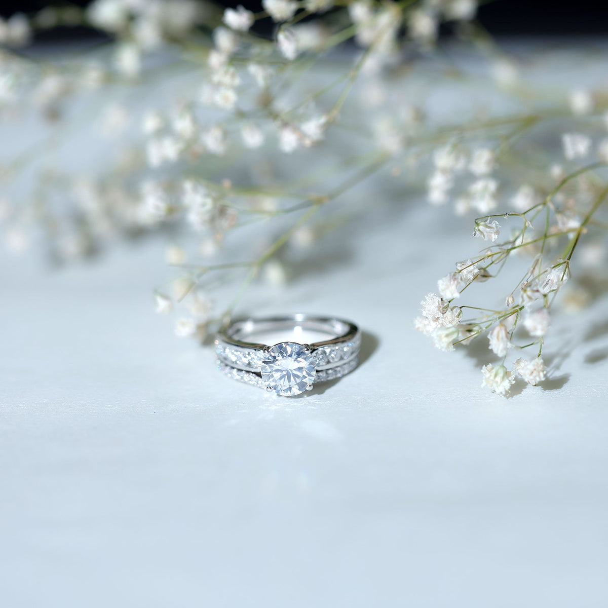 Round 2-carat moissanite engagement ring with matching wedding band from Rosec Jewels, showcasing sparkling gemstone and elegant design.