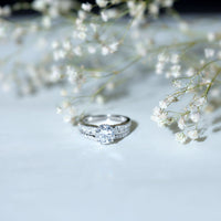 Round 2-carat moissanite engagement ring with matching wedding band from Rosec Jewels, showcasing sparkling gemstone and elegant design.