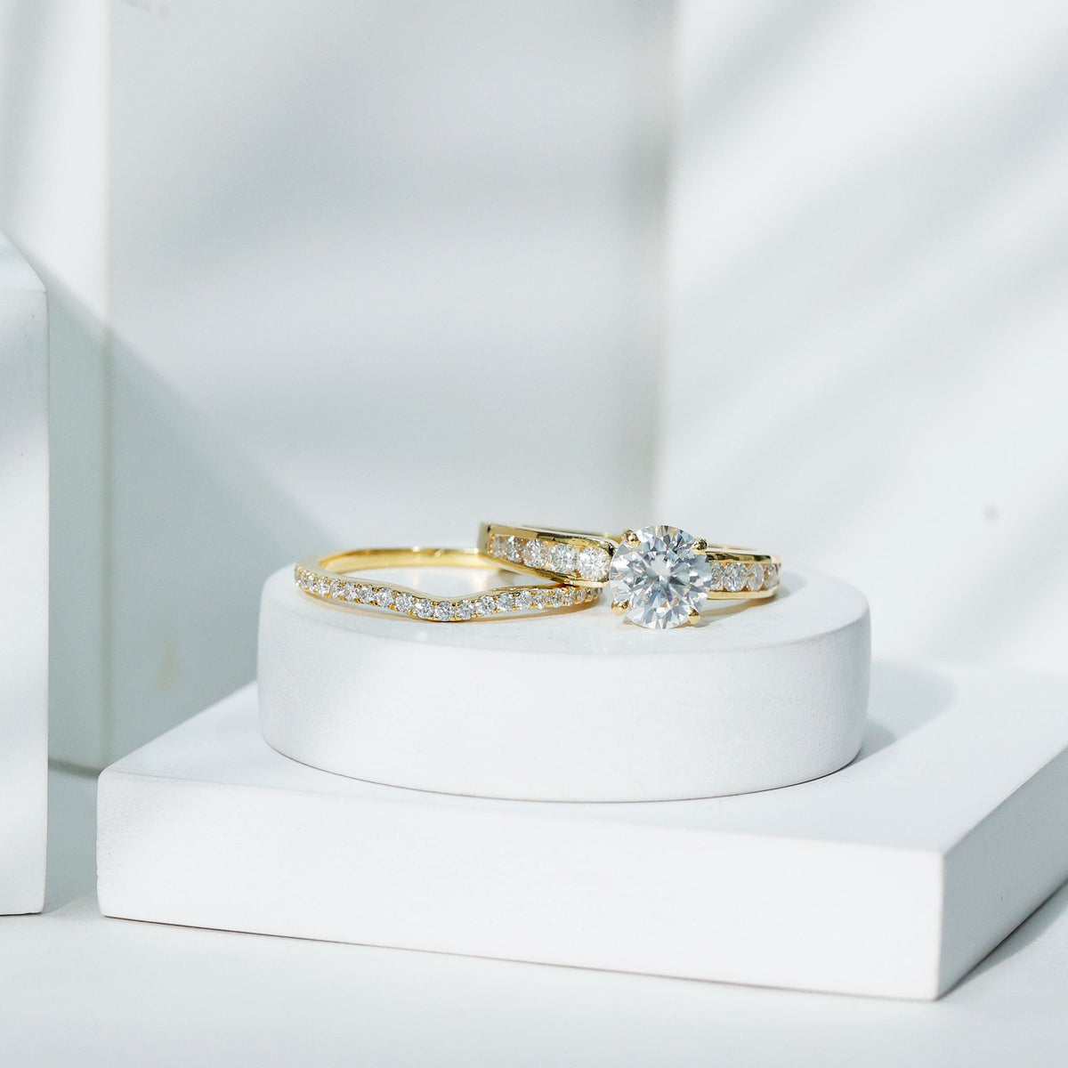 Two-tone Rosec Jewels 2 Carat round moissanite engagement ring with matching wedding band, showcasing sparkling center stone and elegant design.