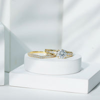 Two-tone Rosec Jewels 2 Carat round moissanite engagement ring with matching wedding band, showcasing sparkling center stone and elegant design.