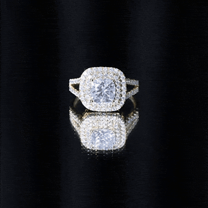 Yellow gold certified cushion cut moissanite double halo engagement ring featuring a central gemstone and intricate halo design.