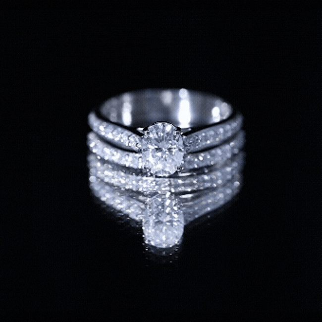 Yellow gold oval moissanite engagement ring set by Rosec Jewels featuring sparkling oval-shaped stones and elegant band design.