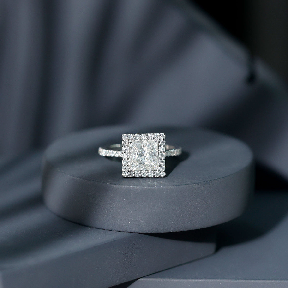 Three-carat princess cut moissanite halo engagement ring by Rosec Jewels with intricate detailing and sparkling center stone.