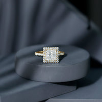 Three-carat princess cut moissanite halo engagement ring with intricate band design, featuring sparkling stones and a platinum finish.
