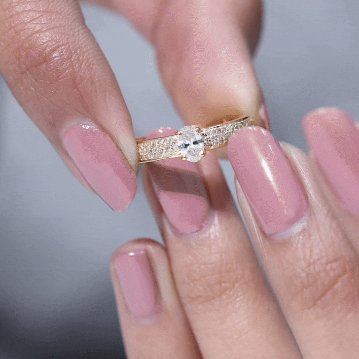 Oval cut diamond engagement ring by Rosec Jewels featuring a classic design with a yellow gold band.