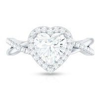 Heart-shaped moissanite halo engagement ring with criss-cross band by Rosec Jewels, showcasing sparkling stones and intricate design.
