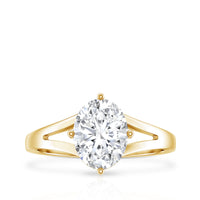 Oval cut moissanite solitaire engagement ring with split shank setting, featuring a shiny band and detailed craftsmanship.