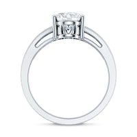 Oval cut moissanite solitaire engagement ring with split shank design by Rosec Jewels, showcasing the elegant ring on a neutral background.