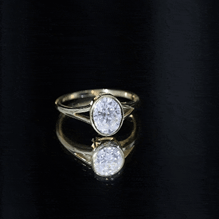 Yellow gold oval moissanite solitaire engagement ring with split shank design by Rosec Jewels.