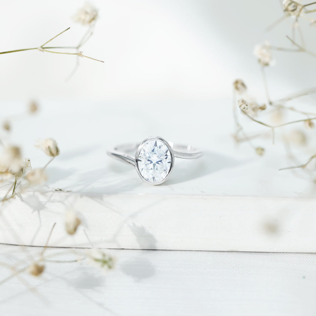 Solitaire 2 Carat Moissanite engagement ring with bezel setting and bypass shank from Rosec Jewels, showcasing a sparkling center stone.