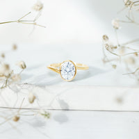 Solitaire 2 carat moissanite bezel set engagement ring with bypass shank by Rosec Jewels, featuring a sparkling center stone and sleek design.