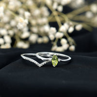 Marquise cut Peridot solitaire wedding ring set with diamond accents from Rosec Jewels, displayed on a white background.