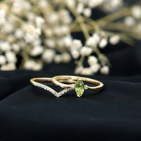 Marquise cut peridot solitaire wedding ring set with diamond accents by Rosec Jewels, featuring a sleek gold band and elegant design.