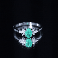 Oval Shaped Emerald Engagement Ring with Marquise Diamond Trio