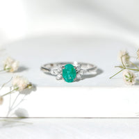 Oval Shaped Emerald Engagement Ring with Marquise Diamond Trio
