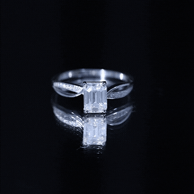 Yellow gold Certified 6x8mm emerald cut moissanite infinity engagement ring by Rosec Jewels showcasing the sparkling center stone and infinity design.