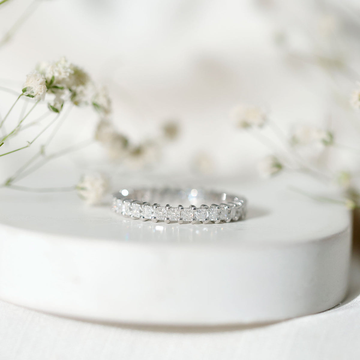 Rosec Jewels princess cut cubic zirconia eternity wedding band ring with certificate, featuring sparkling stones and a sleek silver band.