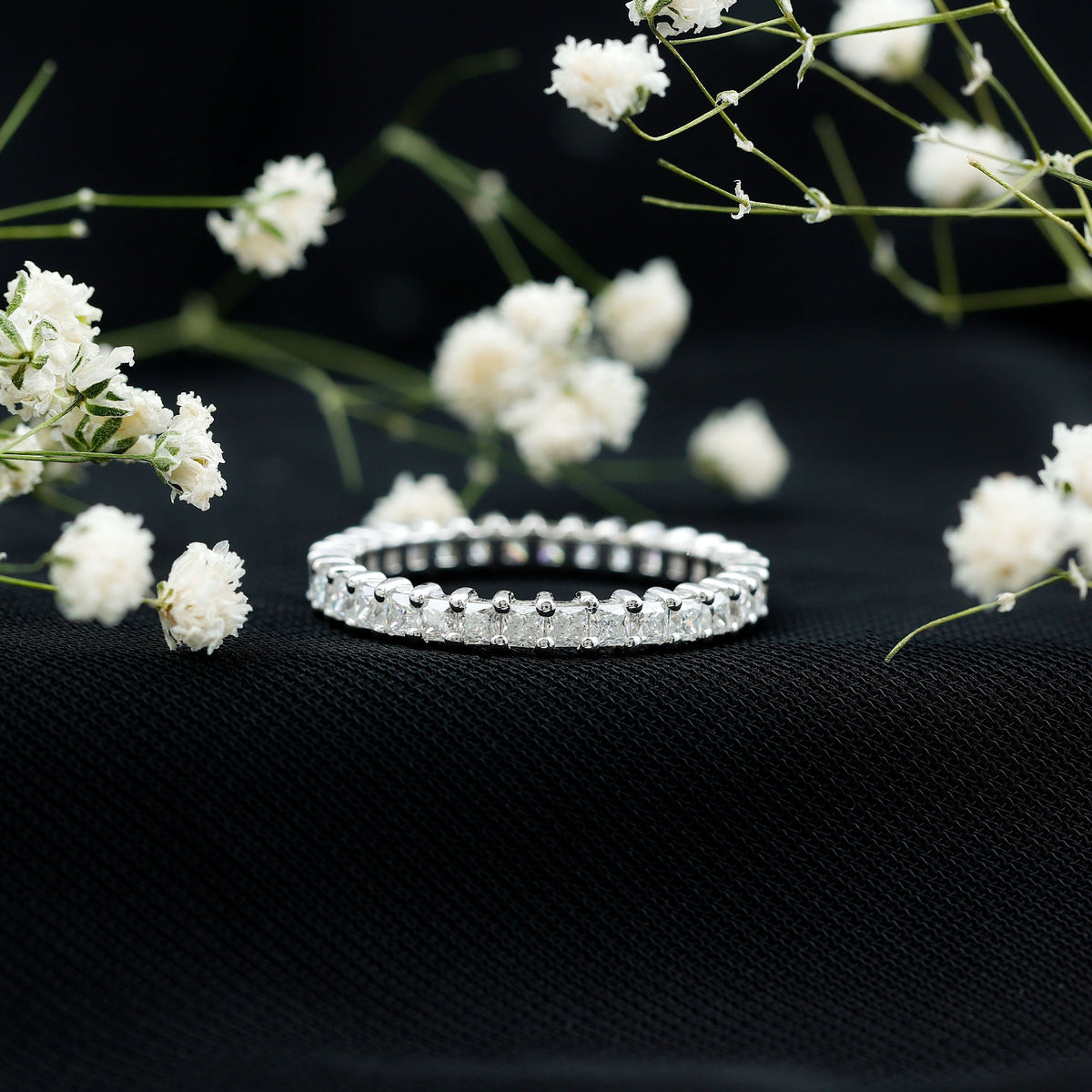 Rosec Jewels princess cut cubic zirconia eternity wedding band ring with certificate, featuring sparkling stones and a sleek silver band.